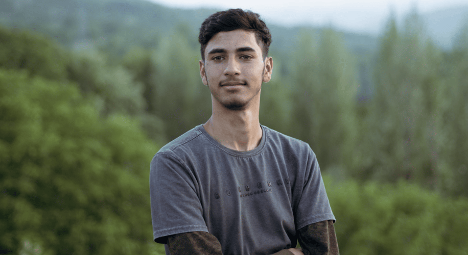 portrait shot of a young man in the woods