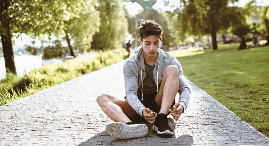 young man tying his shoe