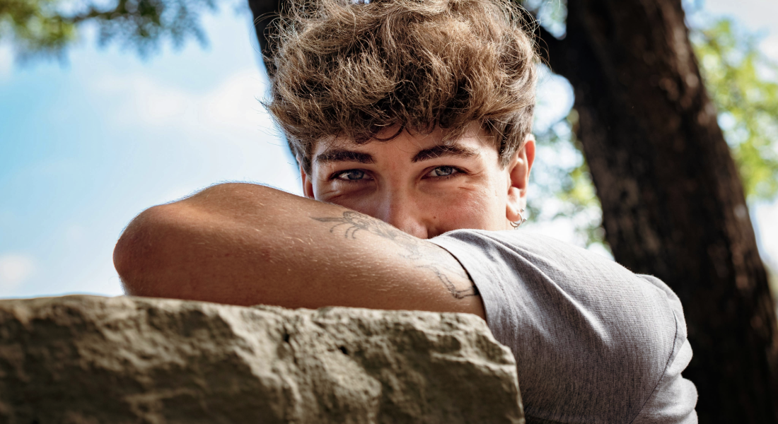 Young man with elbow covering half his face