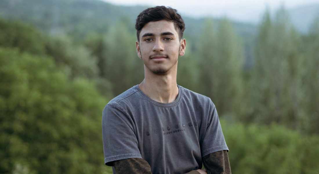 portrait shot of a young man in the woods