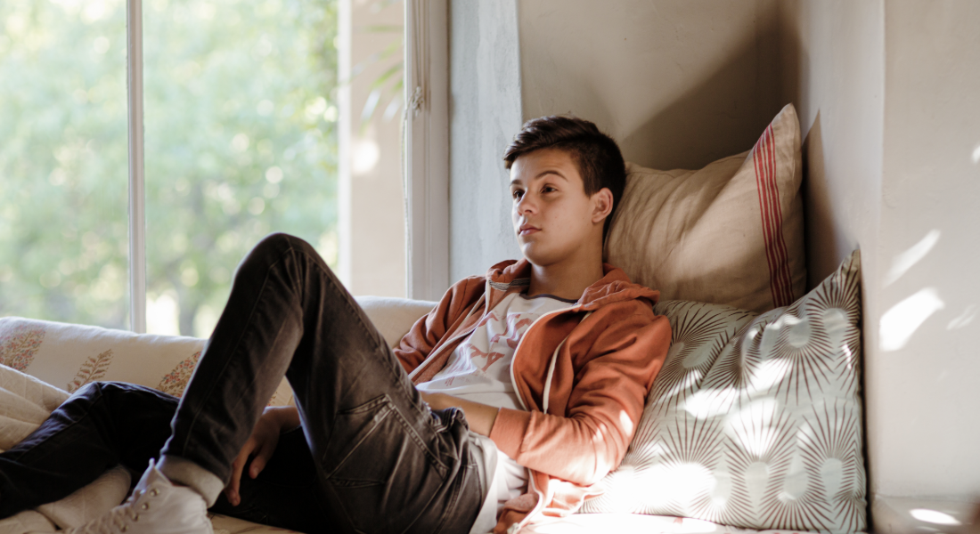 young man reclining in a window nook