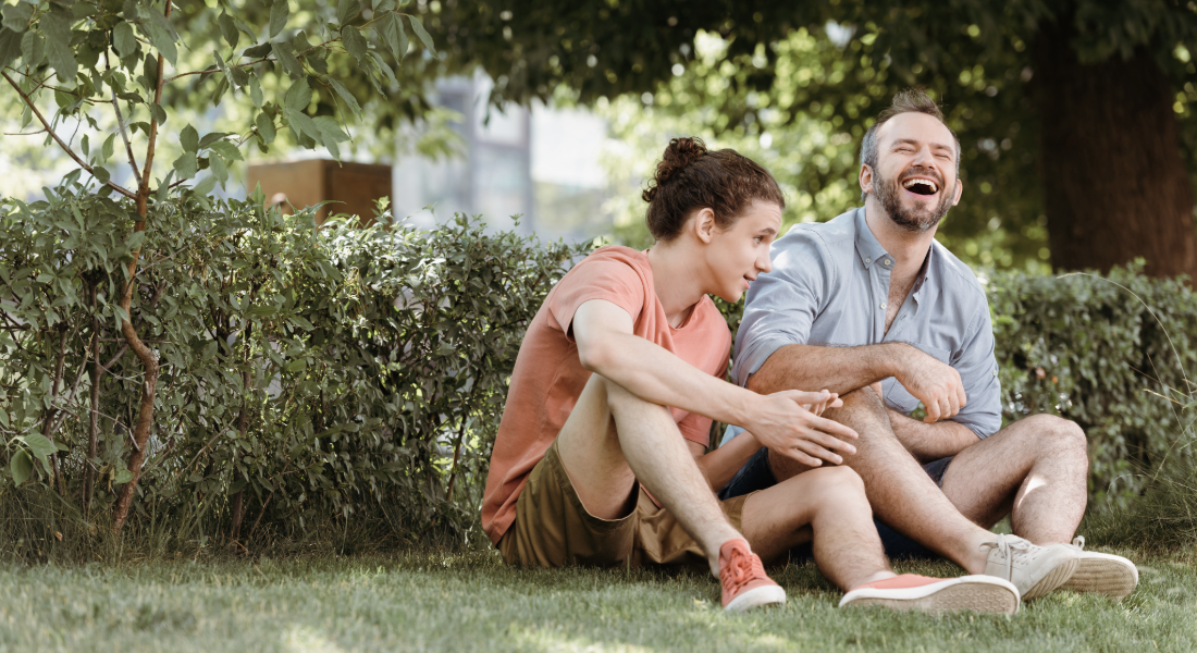 dad and son laughing outside together