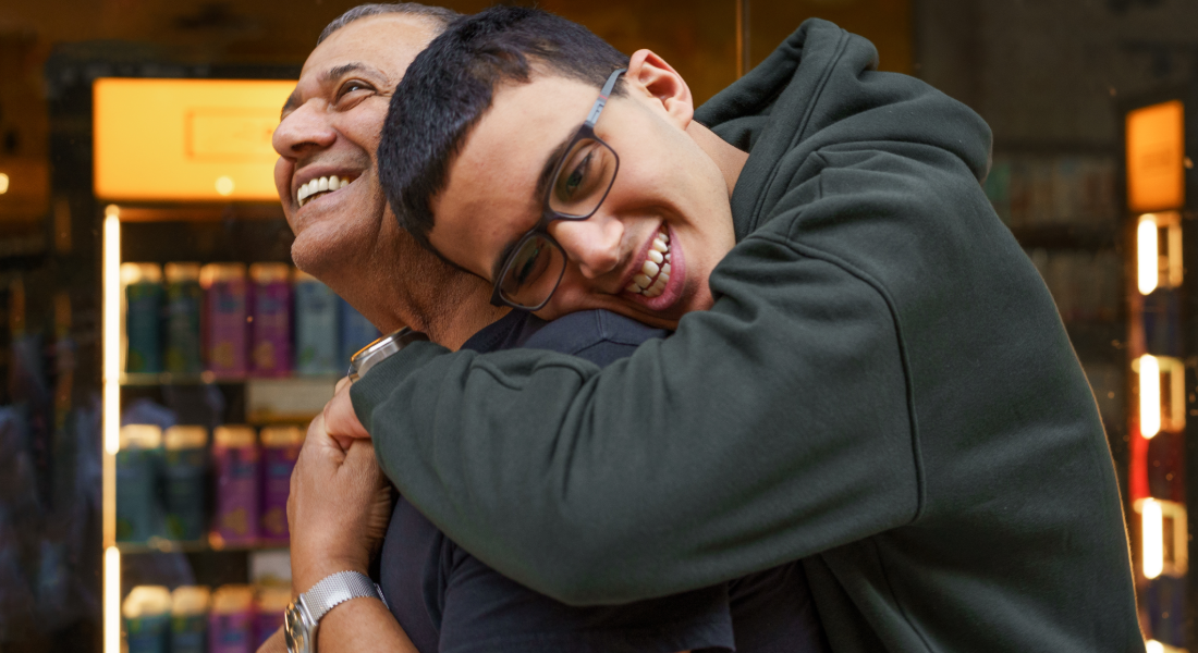 son hugging his father